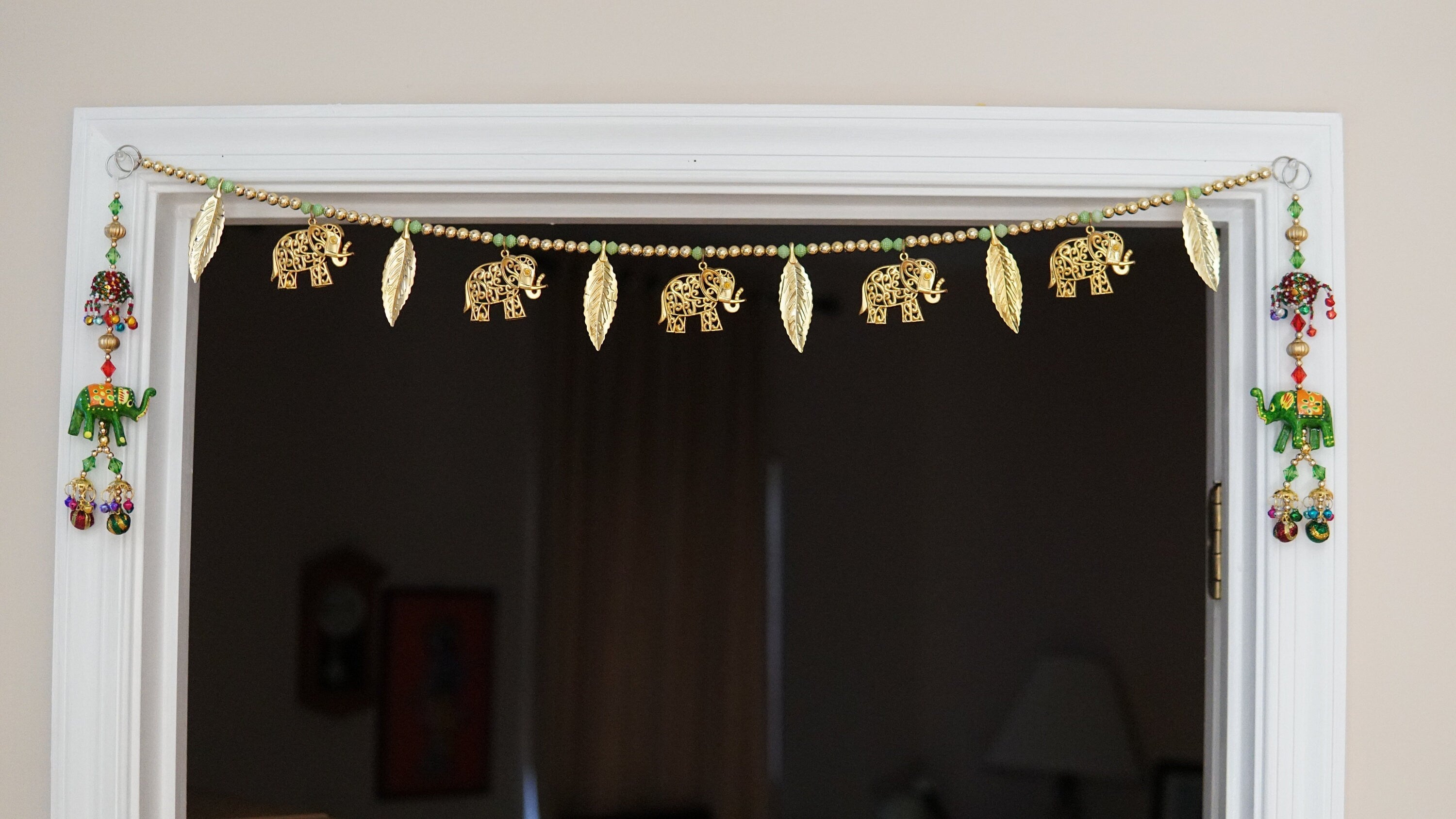 golden elphant toran with white and gold bead and leaves. Beautiful toran for Diwali, house warming and auspicious events and gift giving