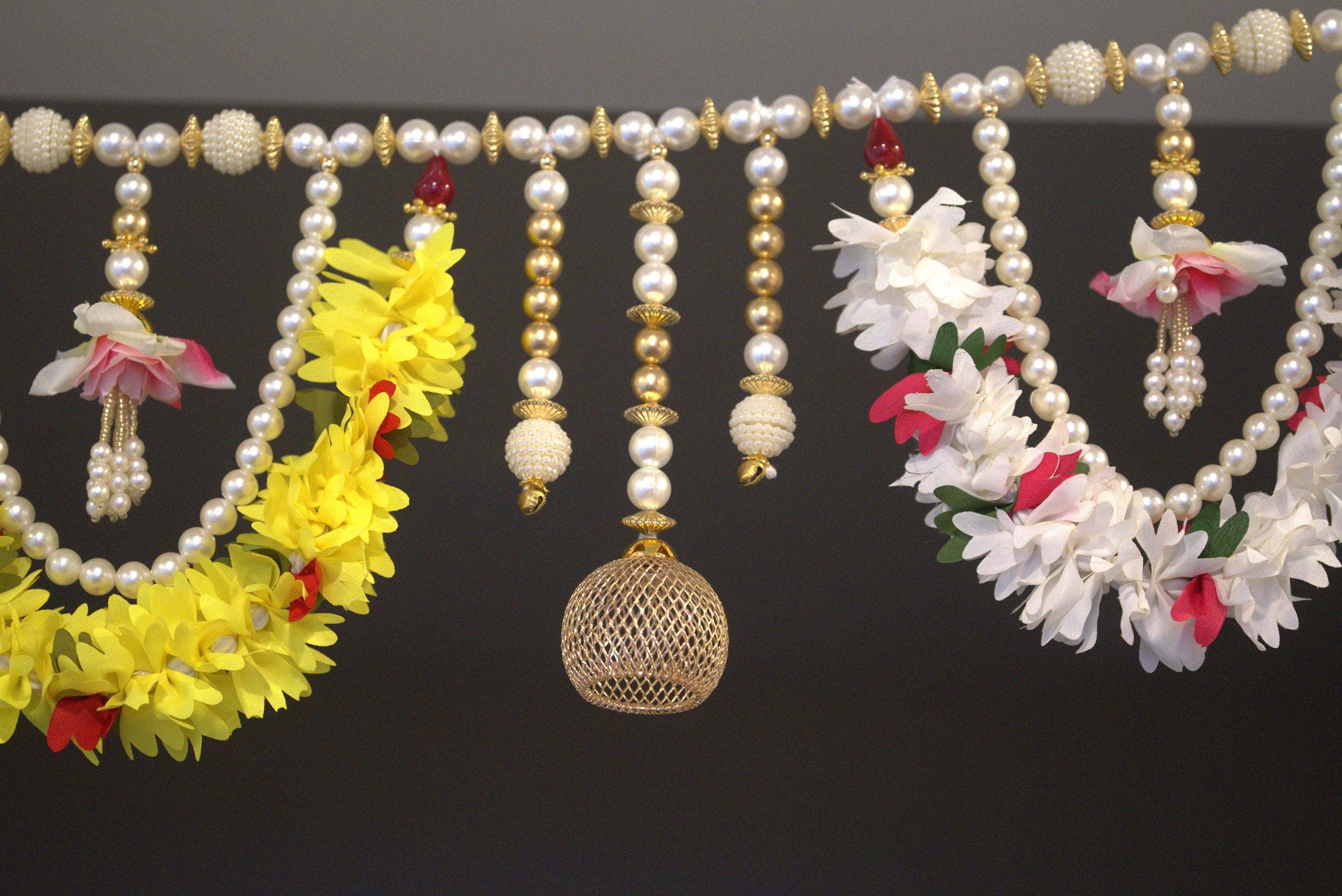 Beautiful pearl bead and golden bead toran made with cloths instead of plastic. Tea light candles can be attached to the golden dangles