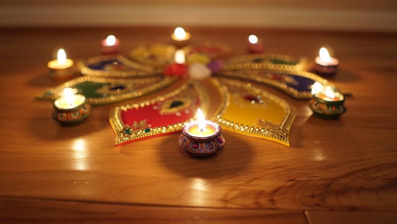 Tabletop decoration: hand-crafted rangoli with ruby and sapphire gems.  This colorful handmade rangoli can be decorated with flowers and diya candles to create relaxing environment during Diwali, Christmas, Henna Mehndi night.