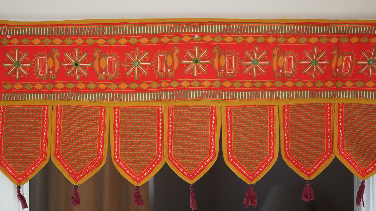 Red leaf-panel toran embroidery and mirror-work detail