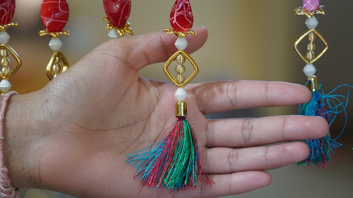 Detail of multicolor acrylic bead groups and long pearl-style sections in the curtain design