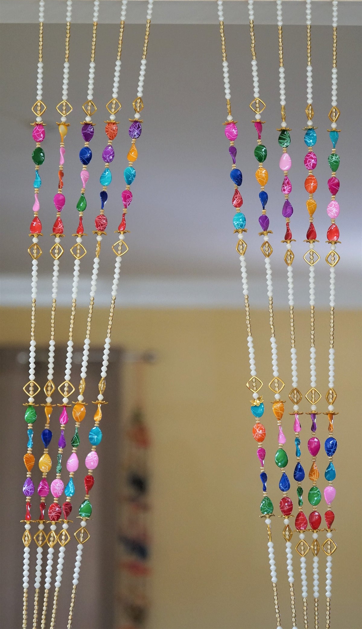 Multicolor beaded curtain strands with long pearl-style sections and gold-tone accents; choose pack quantity and length