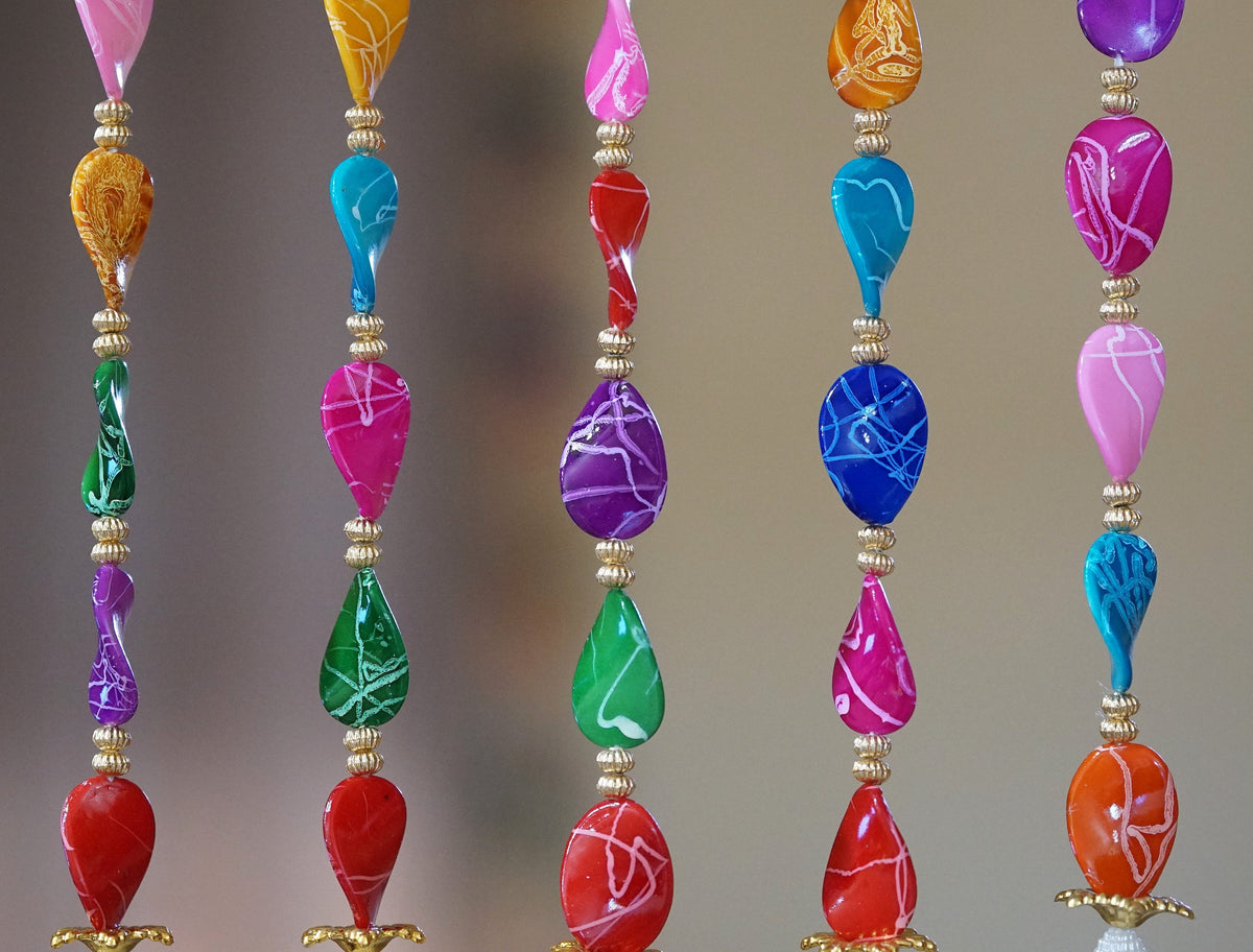 Detail of multicolor acrylic bead groups and long pearl-style sections in the curtain design