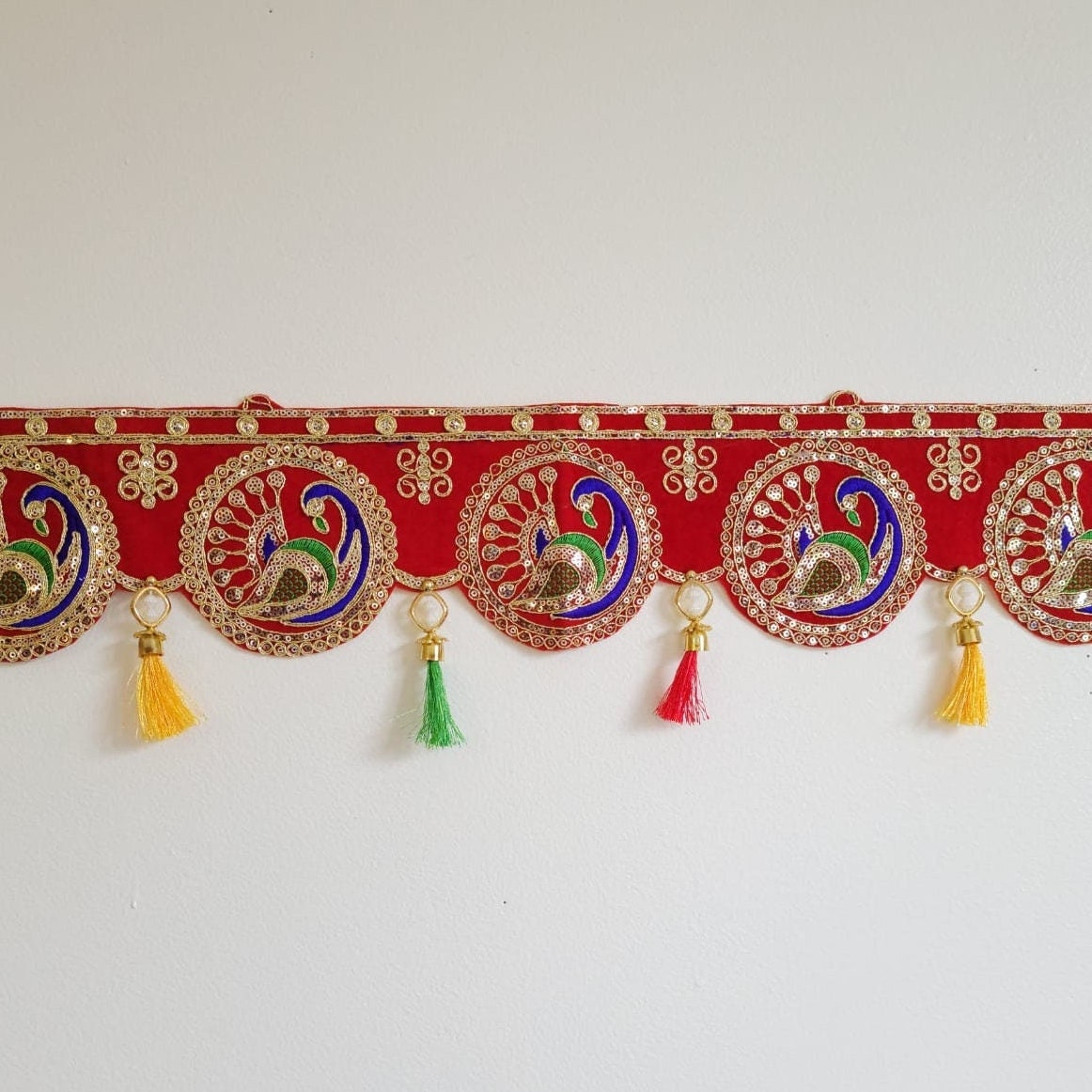 Round peacock embroidered toran with mirror details and colorful silk tassels