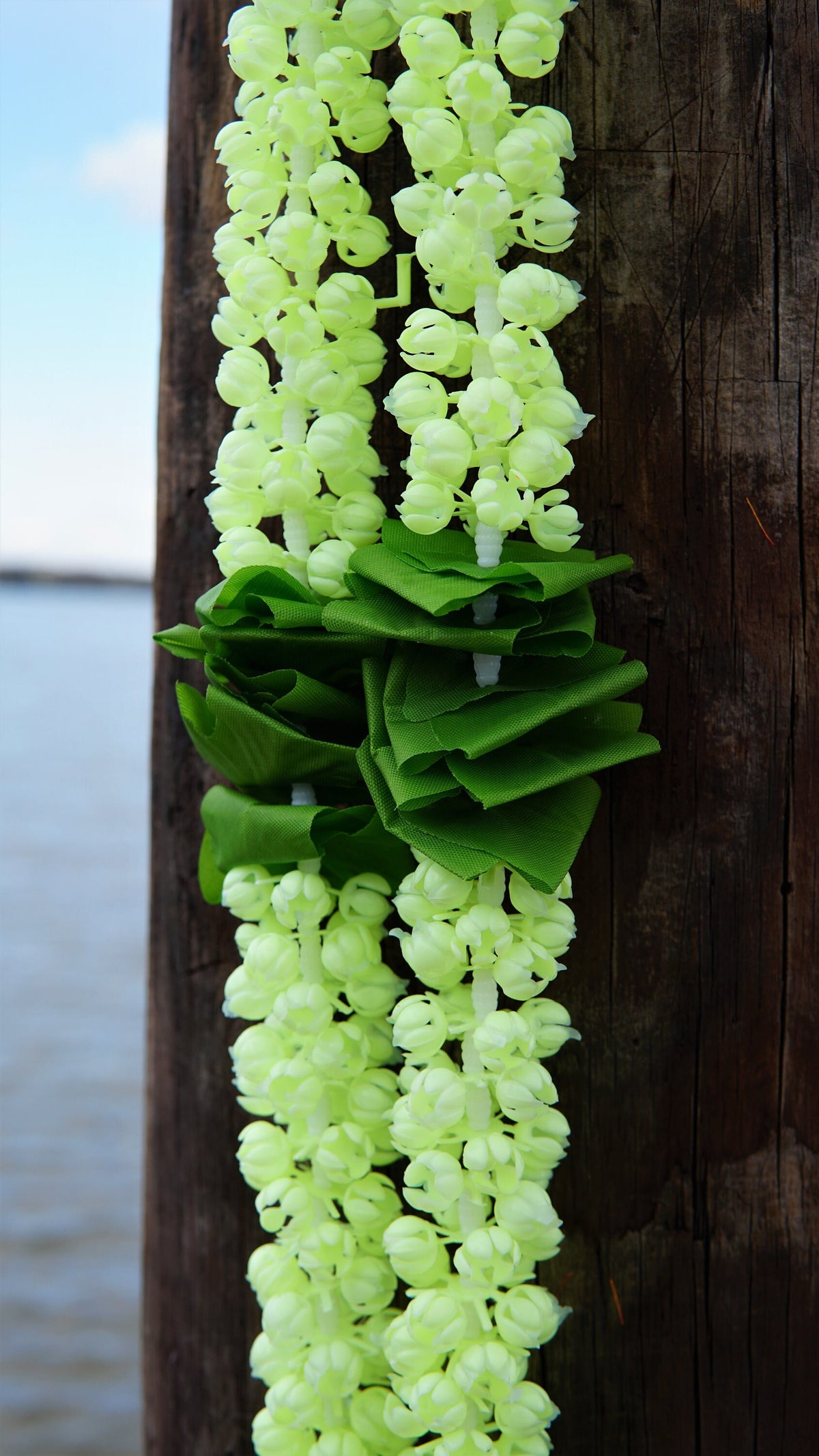 Detail of jasmine-style garland hangings with green accents and orange flowers