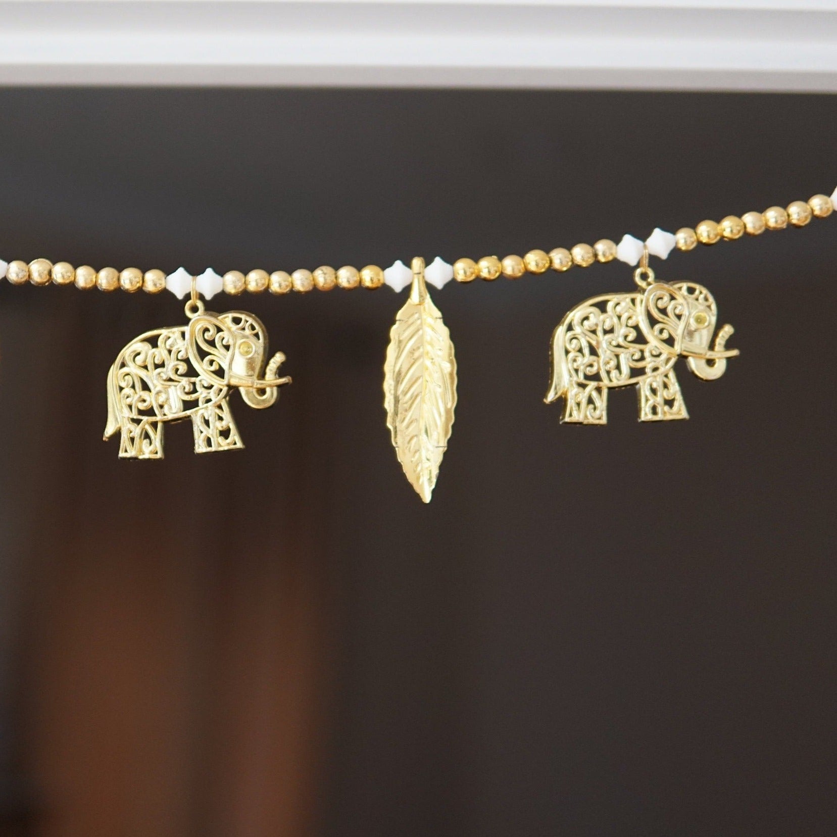 golden elphant toran with white and gold bead and leaves. Beautiful toran for Diwali, house warming and auspicious events and gift giving