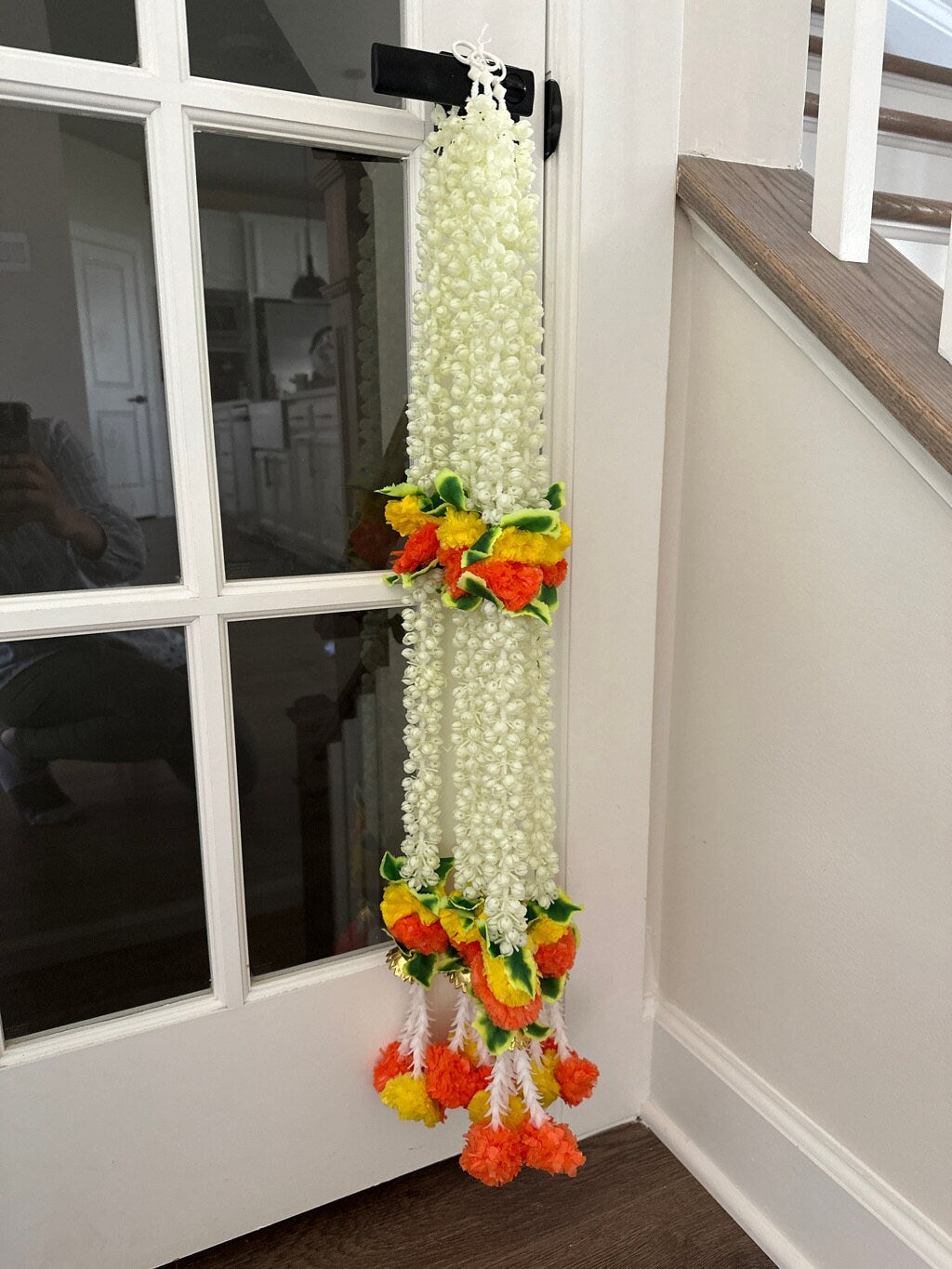Detail of the white artificial jasmine string and orange and yellow accents
